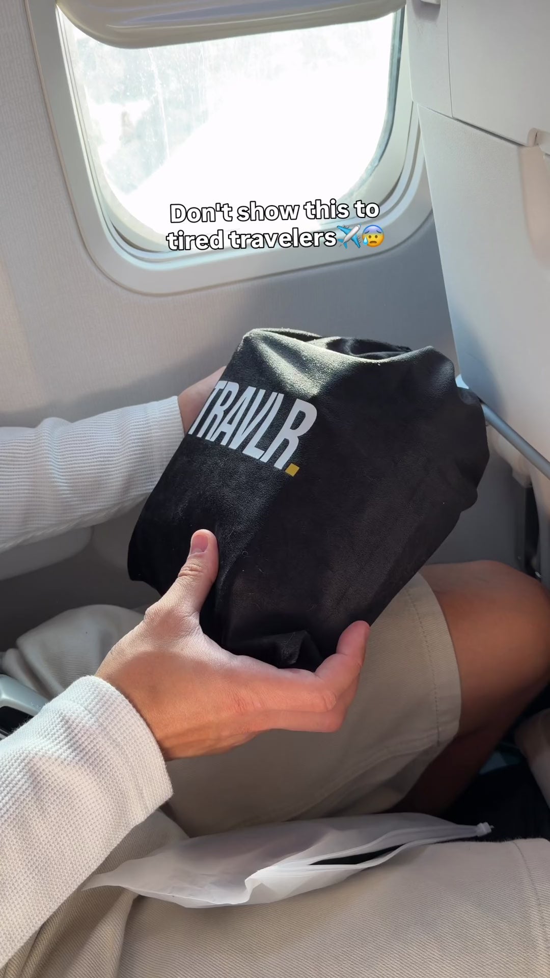 Setting up the TRAVLR cushion on a plane seat